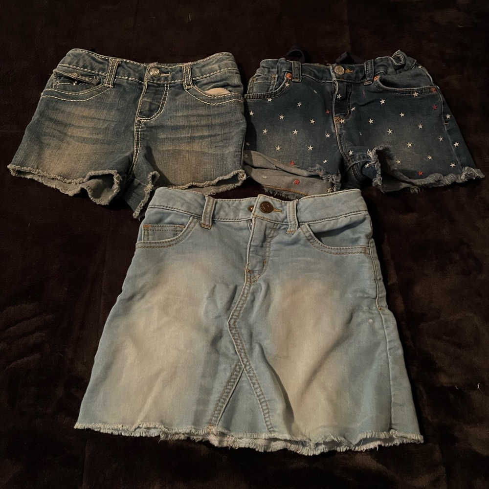 Two girls jean shorts, one skirt